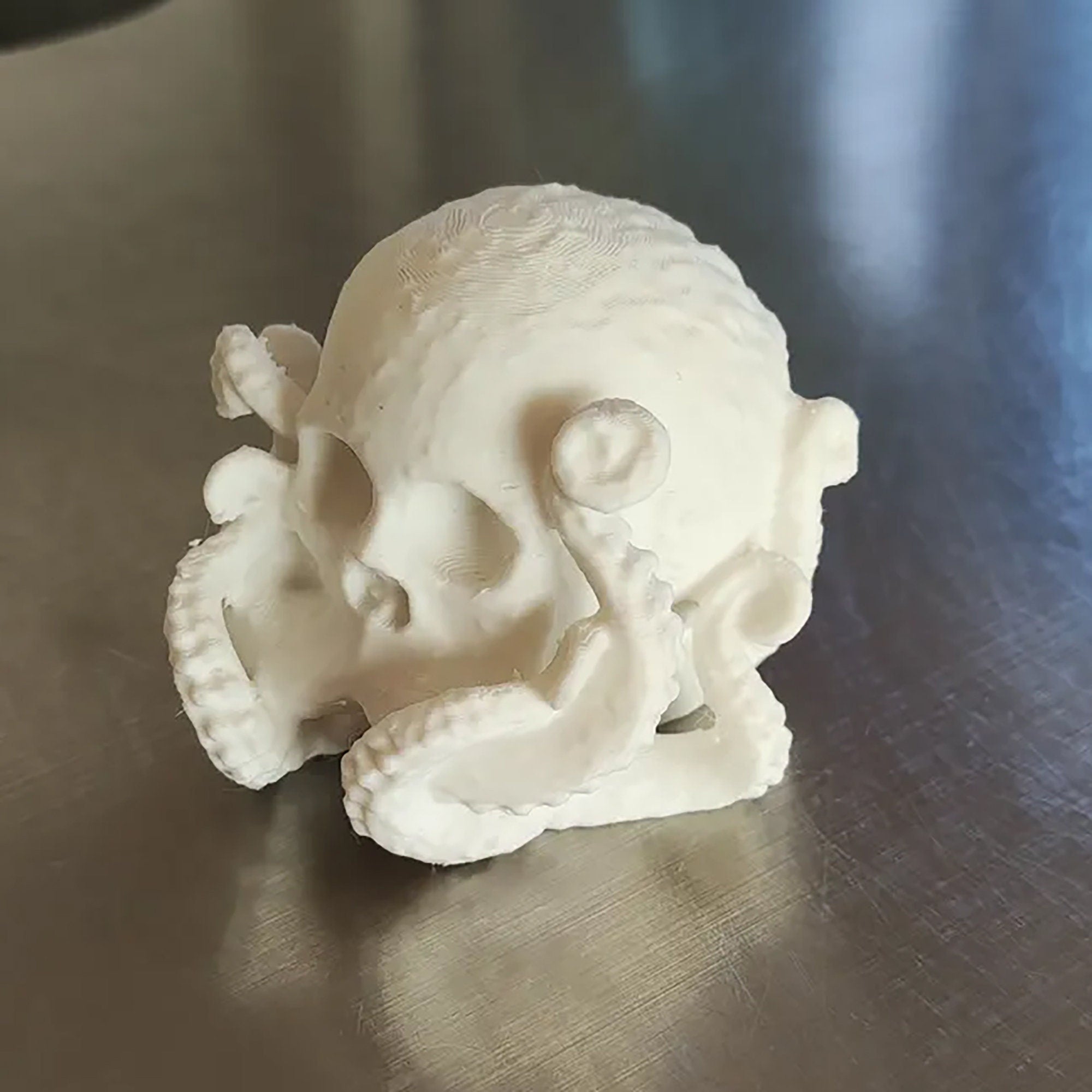 a white sculpture of a skull on a table