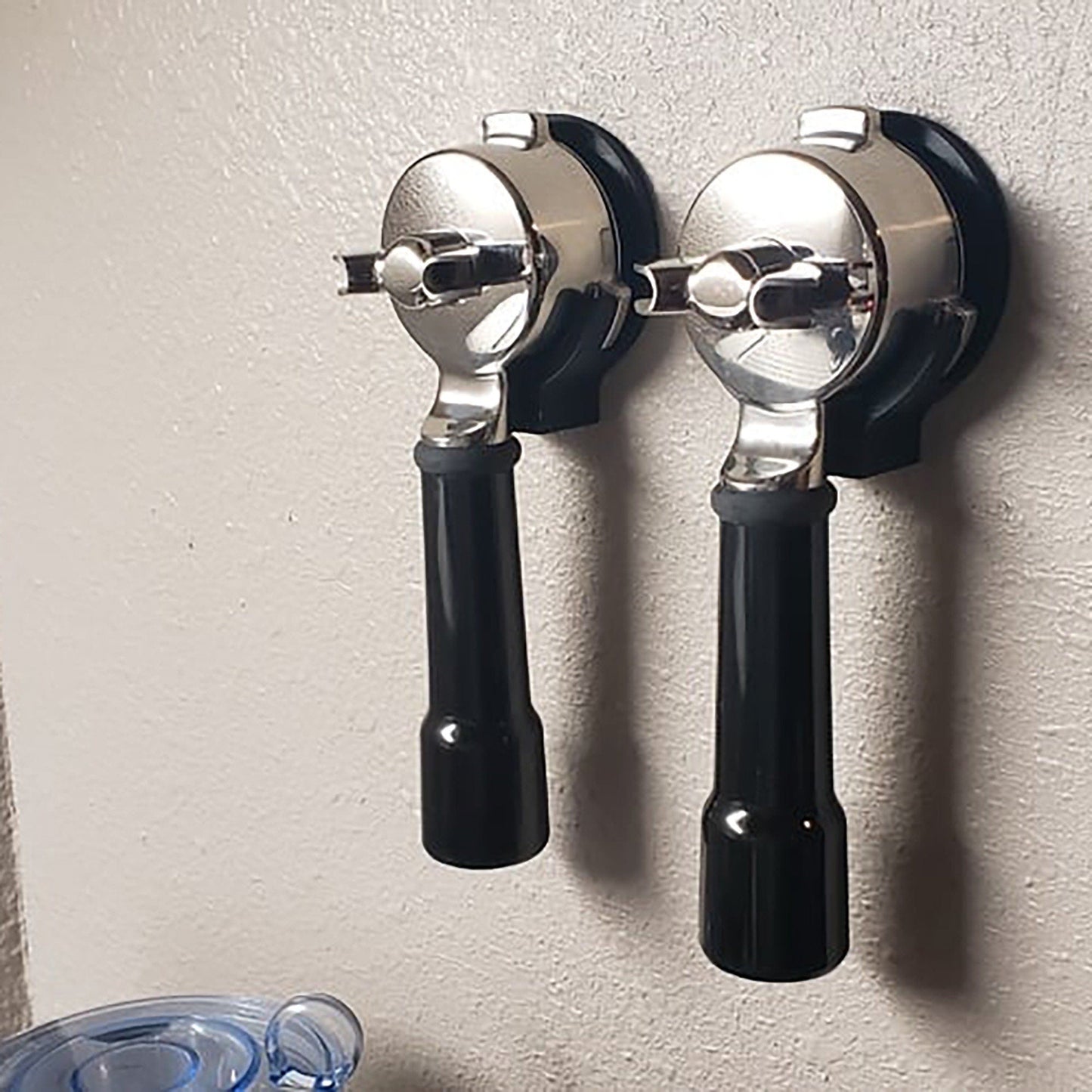 two black and chrome wall mounted hair dryers
