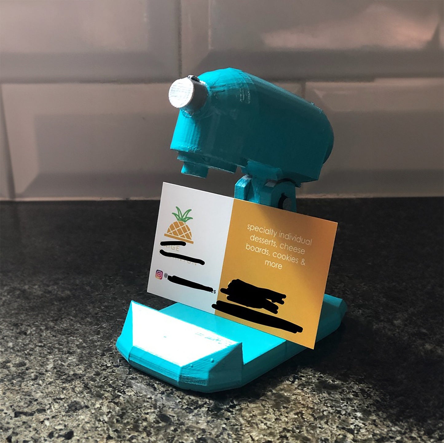 a blue and gold business card holder on a counter