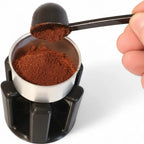 Funnel holder cradling a Bialetti Moka pot filter funnel upright on the counter, view 3