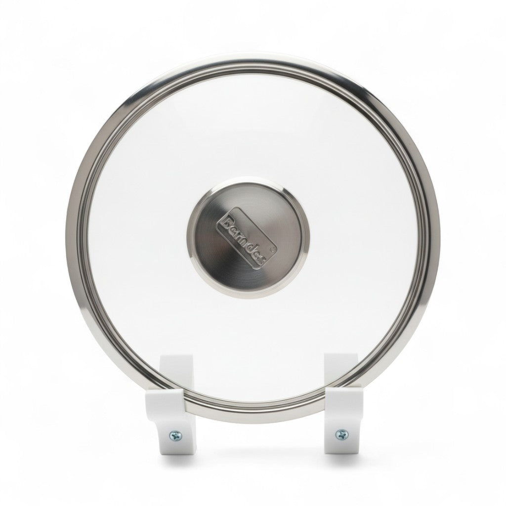 Wall mounted pot lid holder on a cabinet side holding a glass lid upright