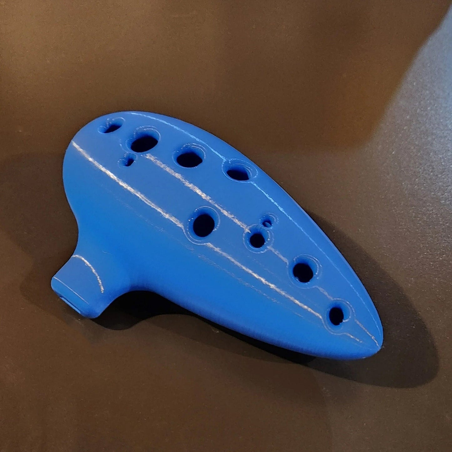 a blue plastic object sitting on top of a table