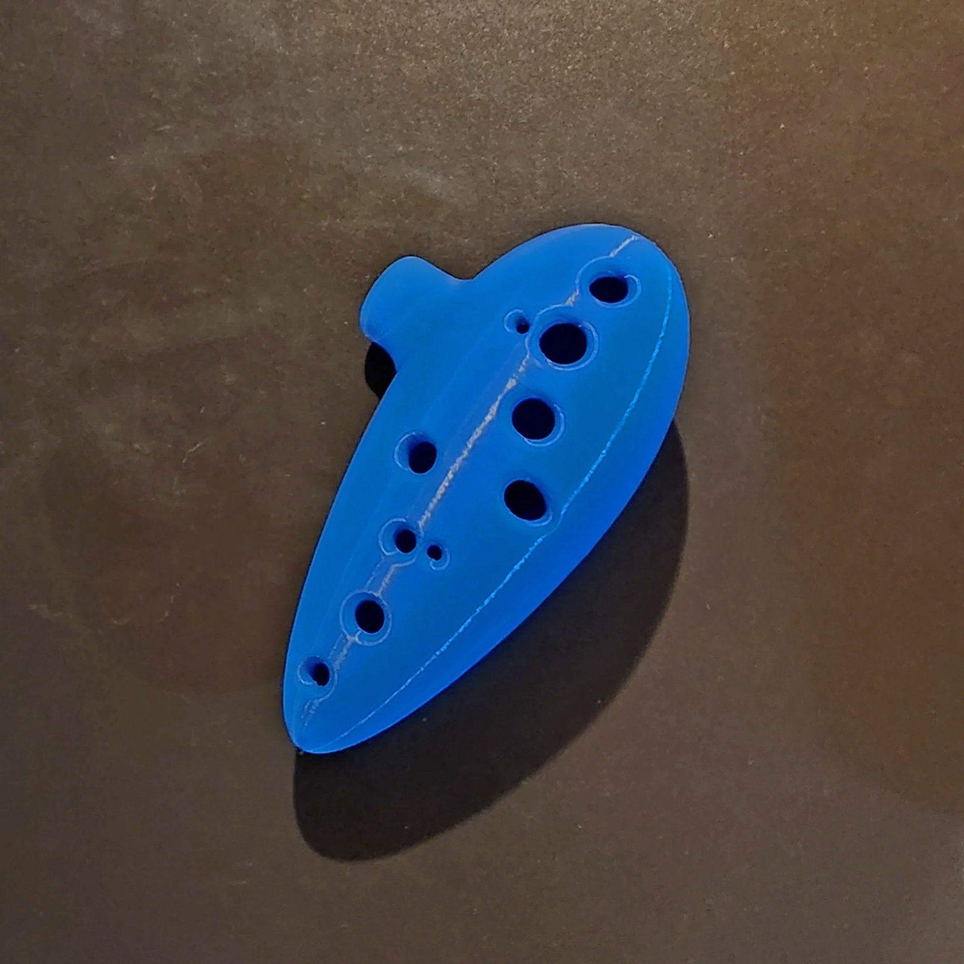 a blue plastic object sitting on top of a table