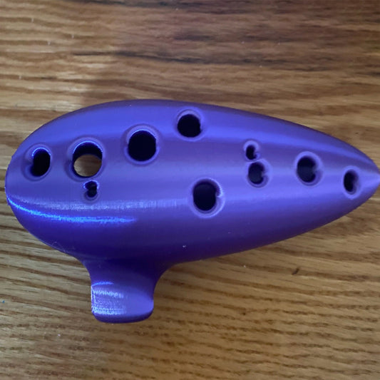 a purple object sitting on top of a wooden table