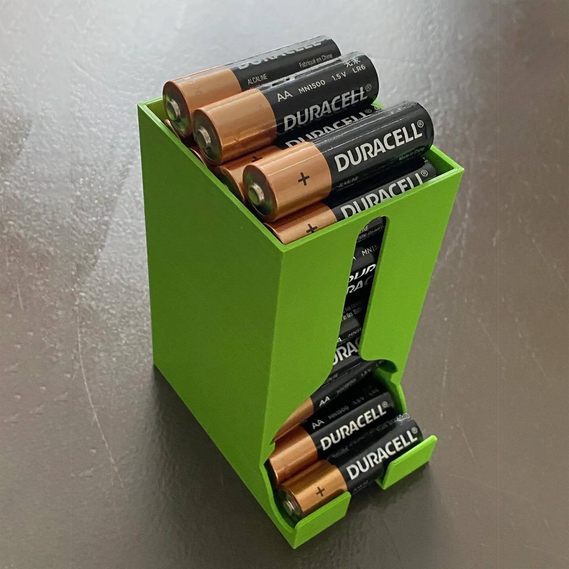 a green box with four batteries in it