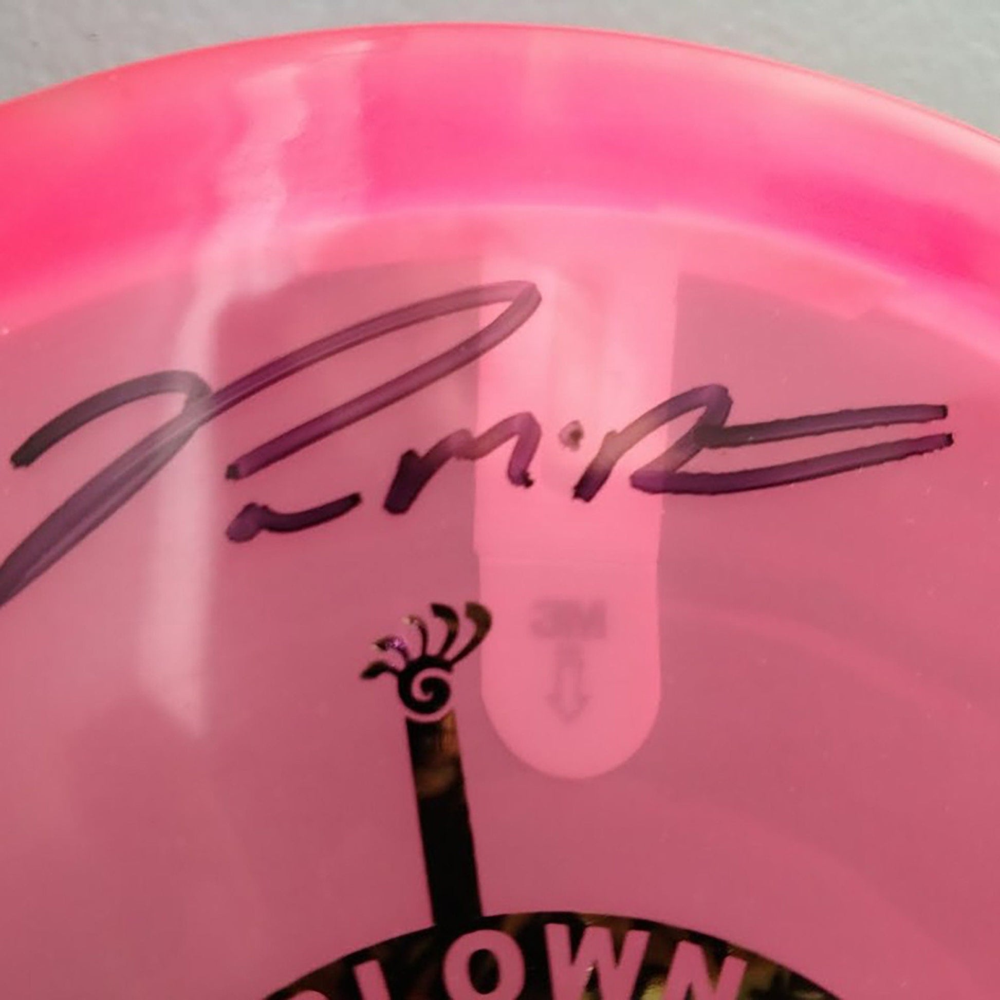 a pink frisbee with a picture of a clock on it