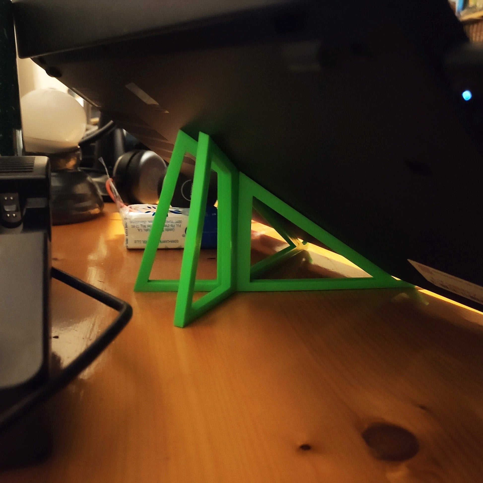 a computer desk with a green triangle on top of it