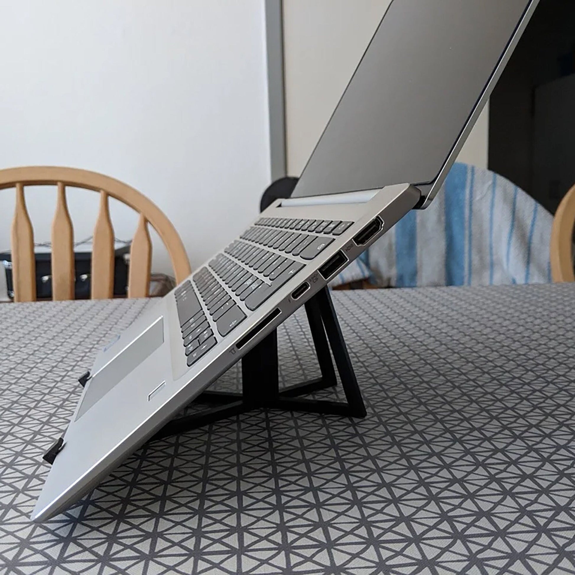 a laptop computer sitting on top of a wooden table