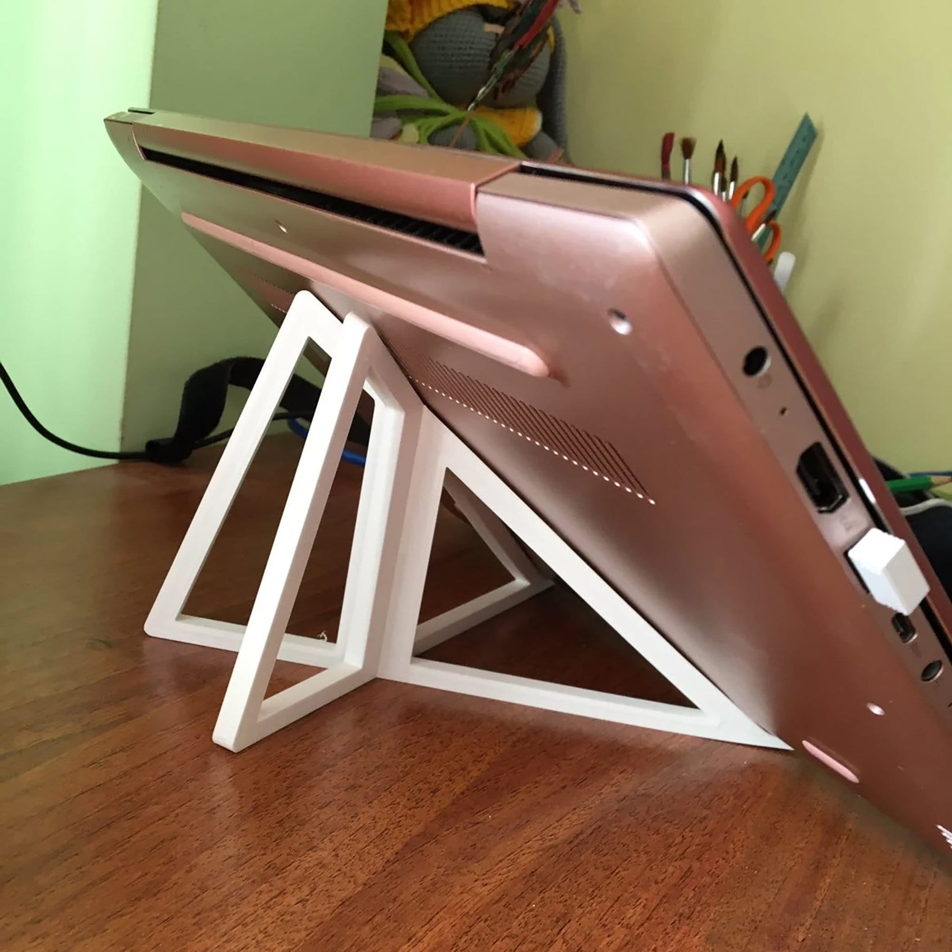 a laptop computer sitting on top of a wooden desk