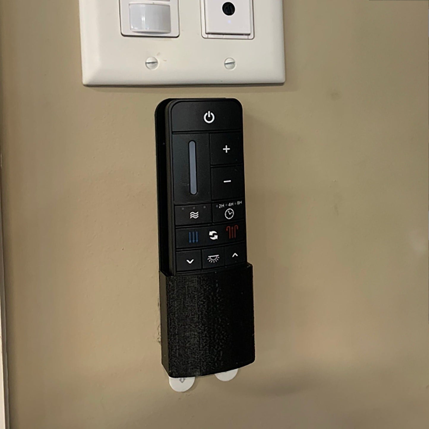 a remote control attached to a wall in a room