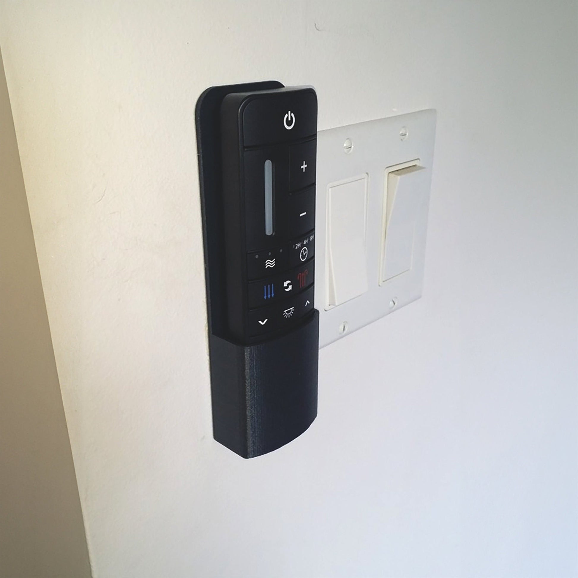 a remote control mounted to the side of a wall