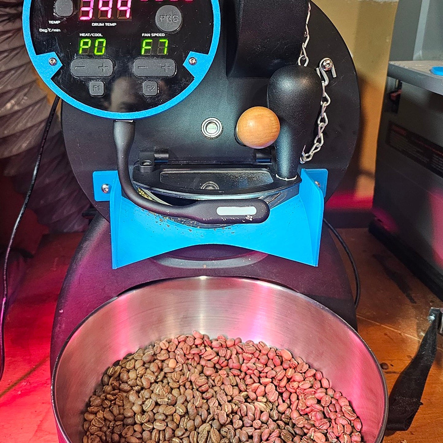 a metal bowl filled with food next to a machine