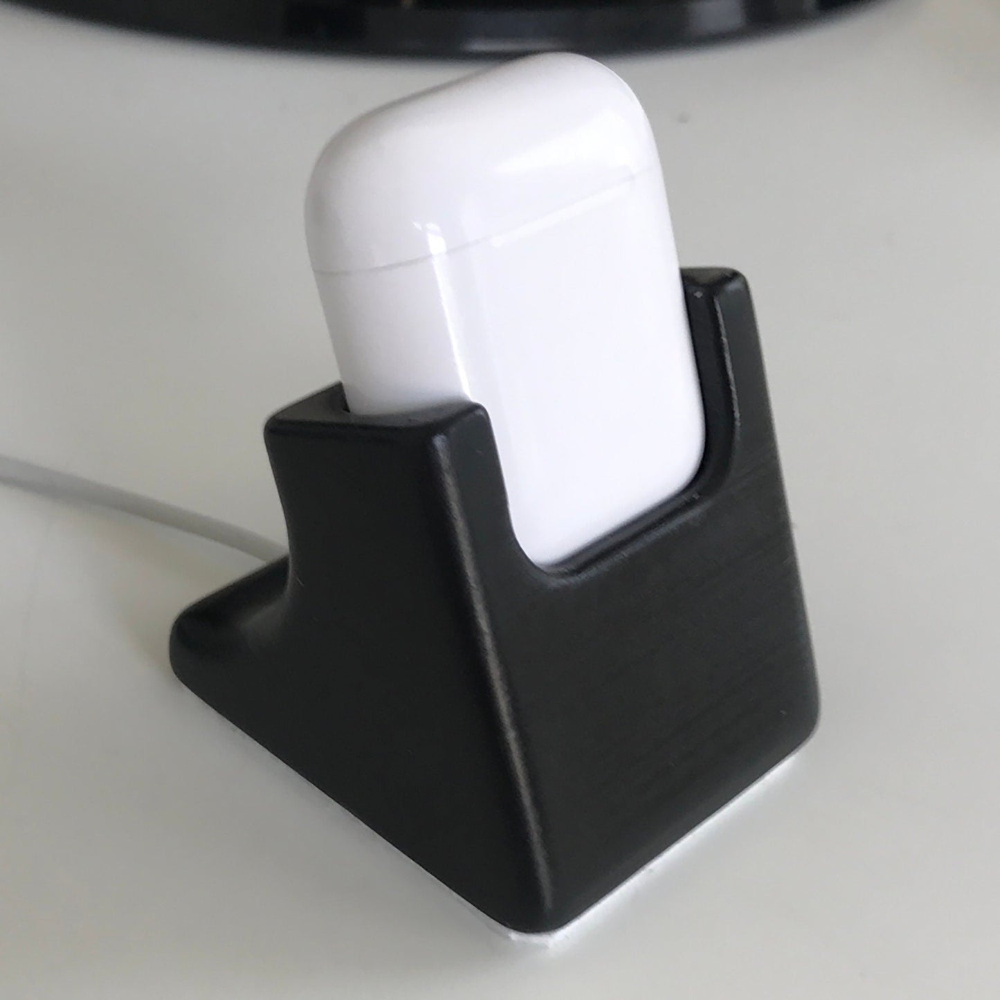 a black and white device holder on a table