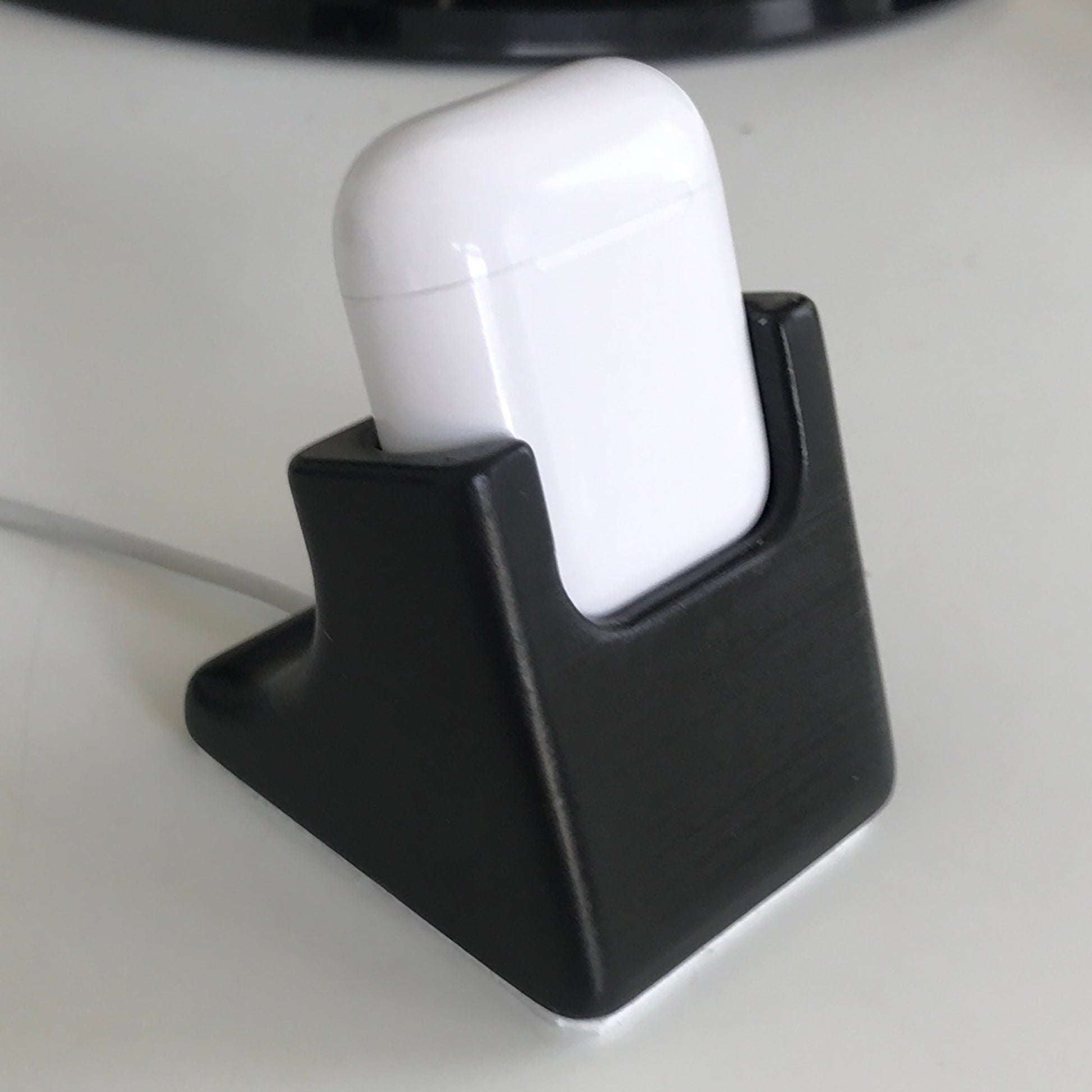 a black and white device holder on a table