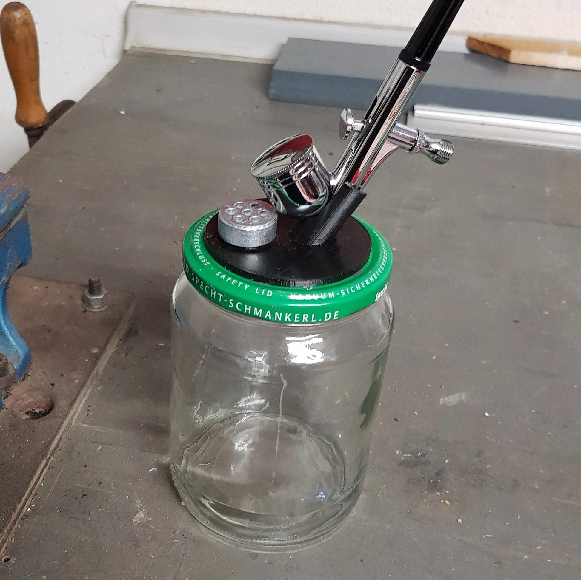 a glass jar with a baseball bat and a baseball cap on top of it