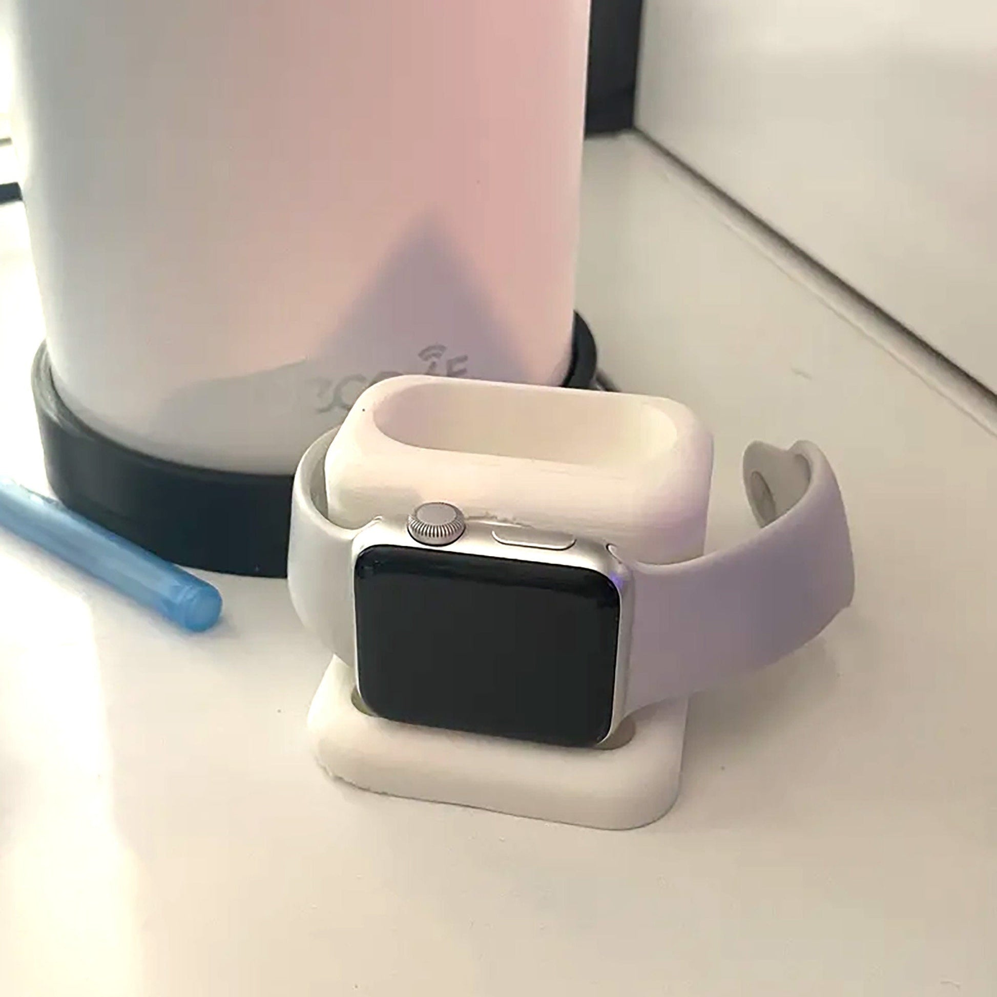 a white apple watch sitting on top of a table