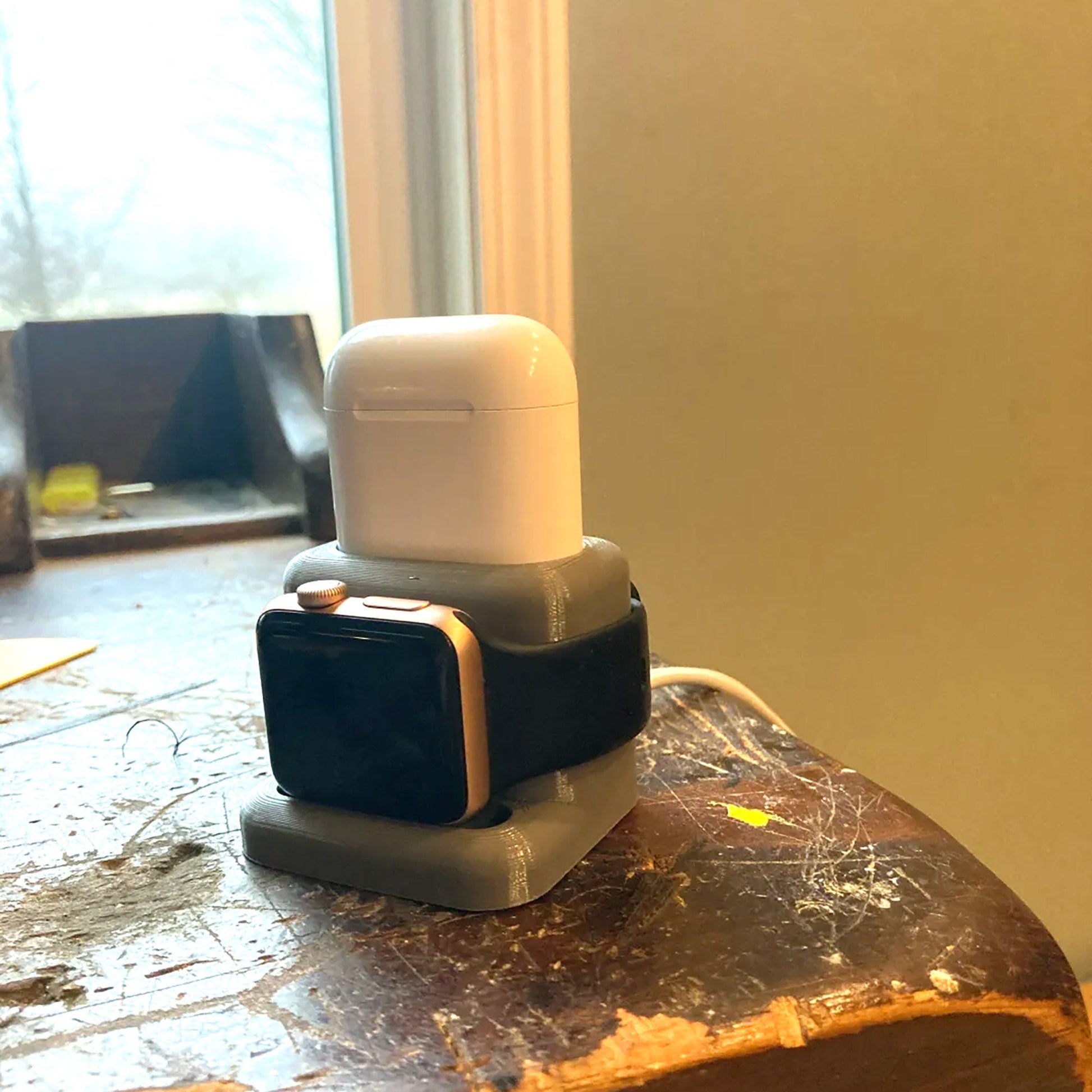 a cell phone holder sitting on top of a wooden table