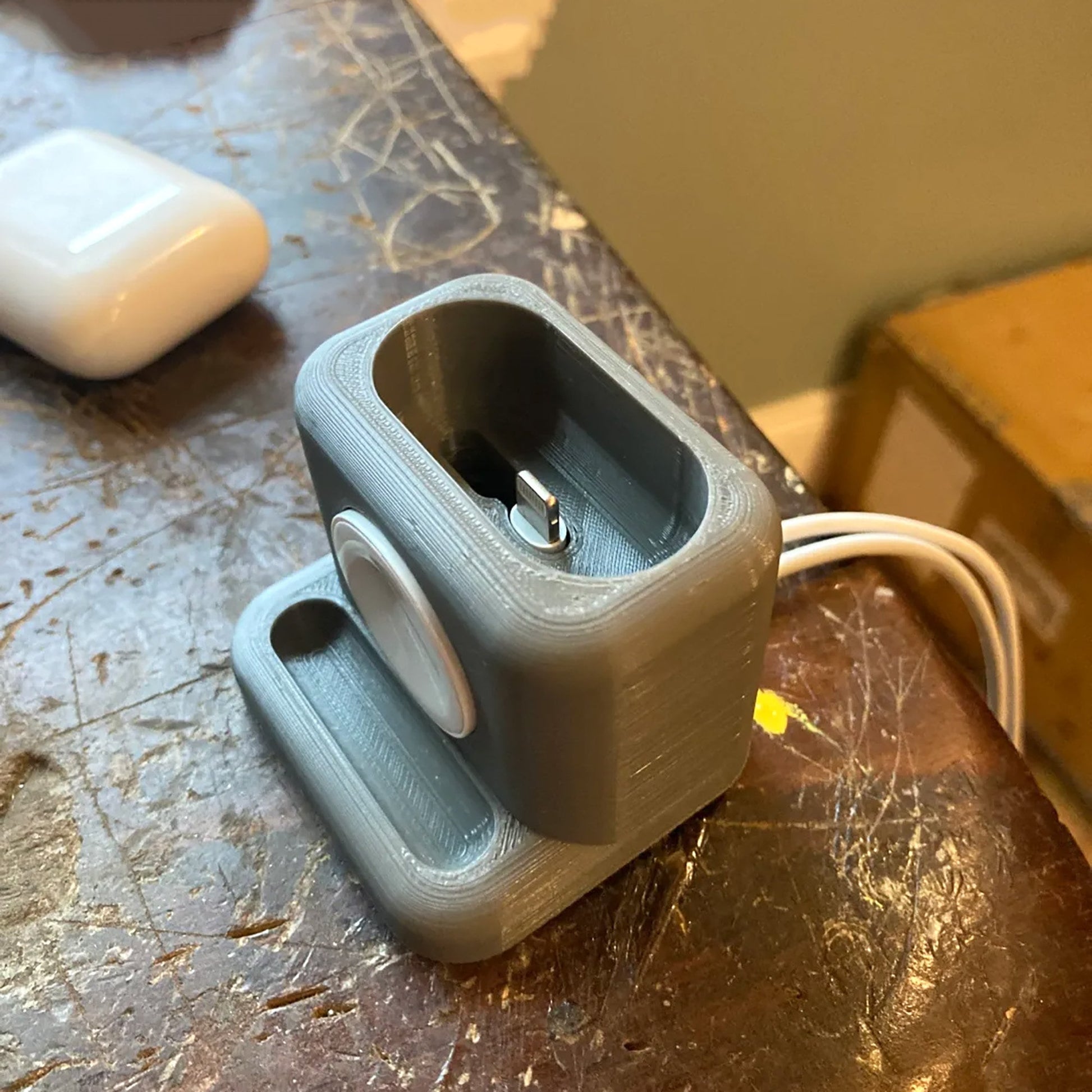 a gray object sitting on top of a wooden table