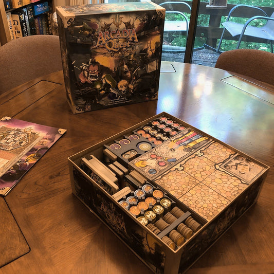 a wooden table topped with a metal box filled with games