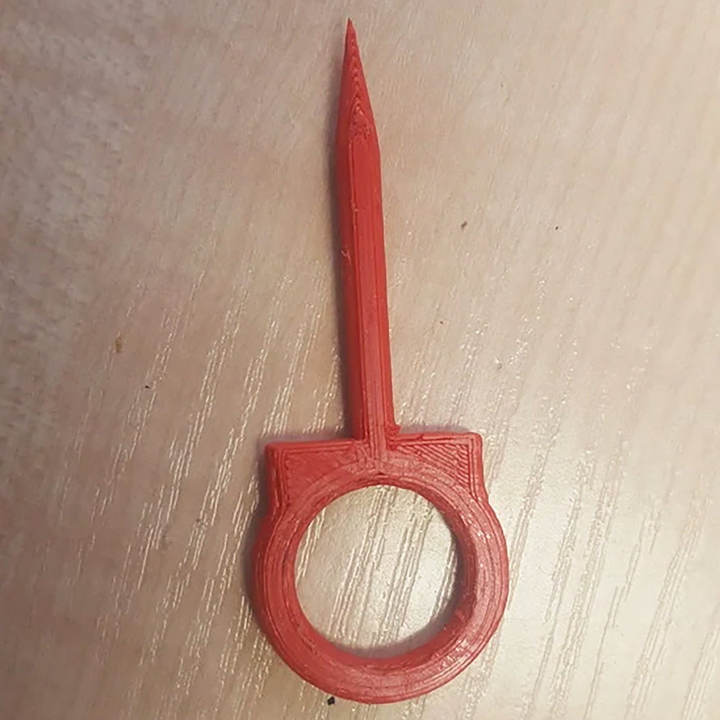 a pair of scissors sitting on top of a wooden table