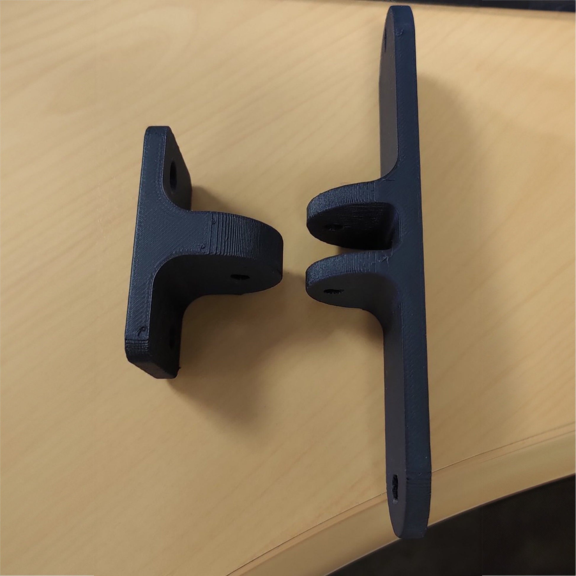 a close up of two black handles on a table