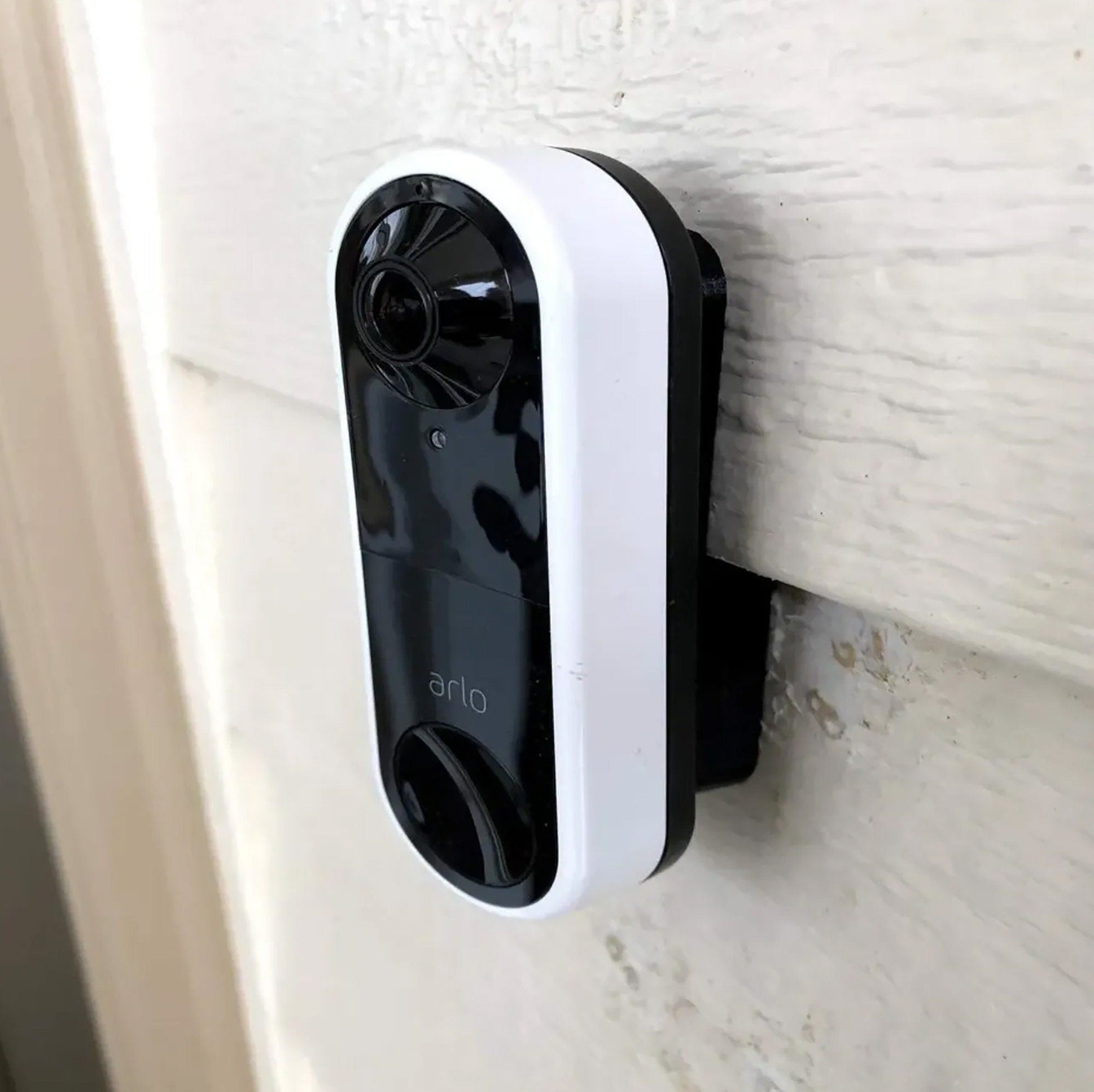 a black and white camera mounted on the side of a door