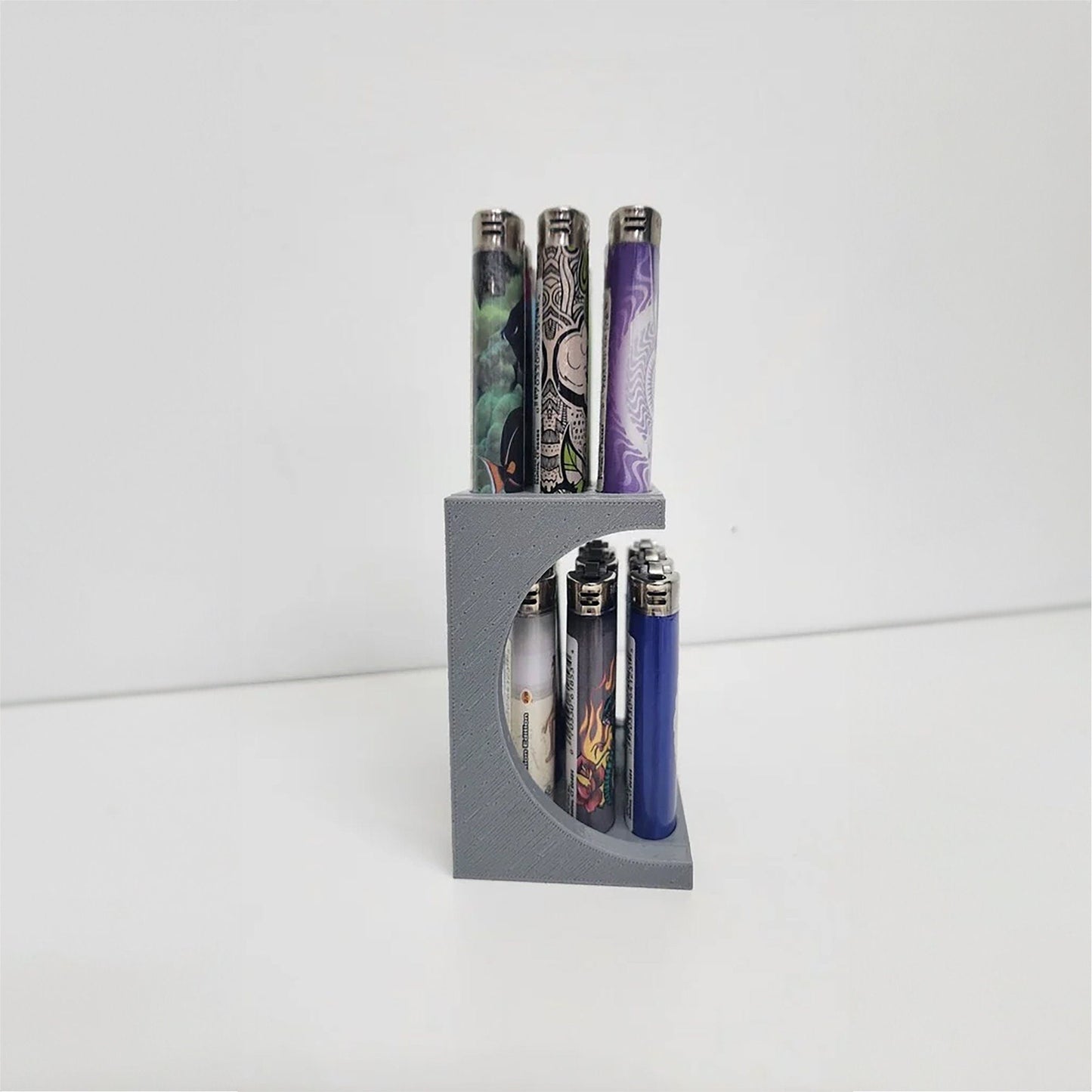 a set of four lighters sitting on top of a holder