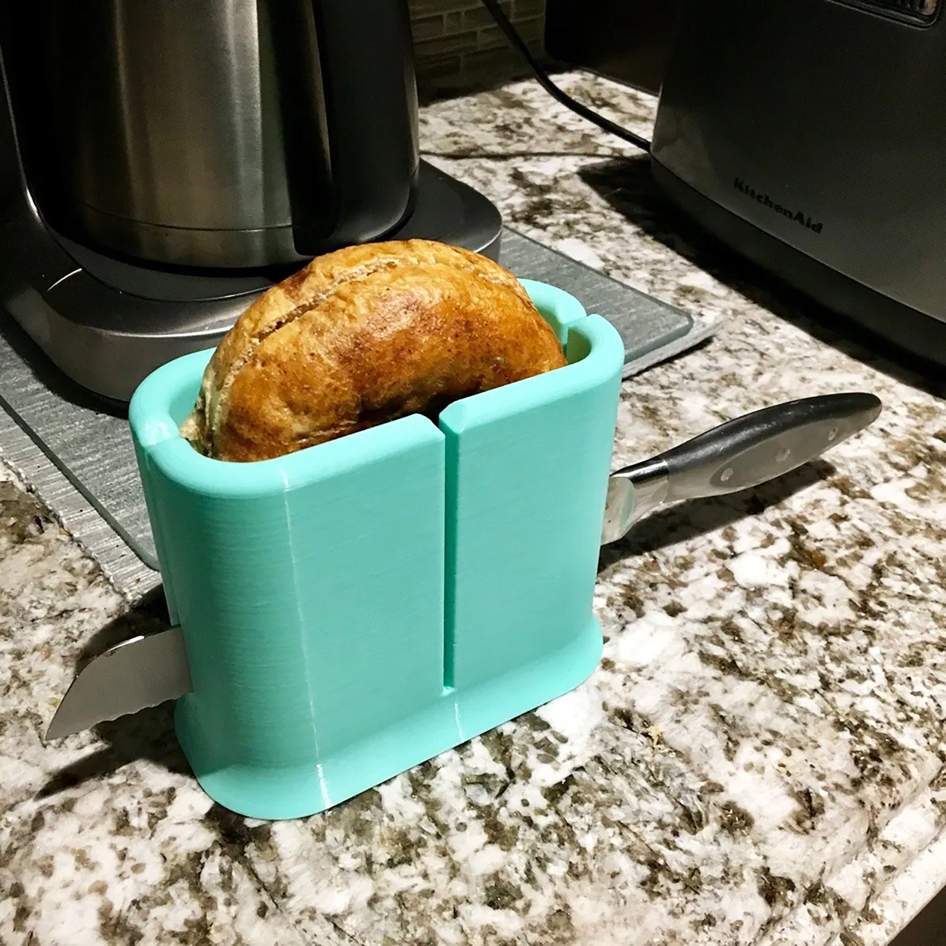 a loaf of bread in a blue container on a counter