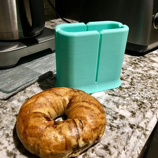 a bagel sitting on a counter next to a toaster