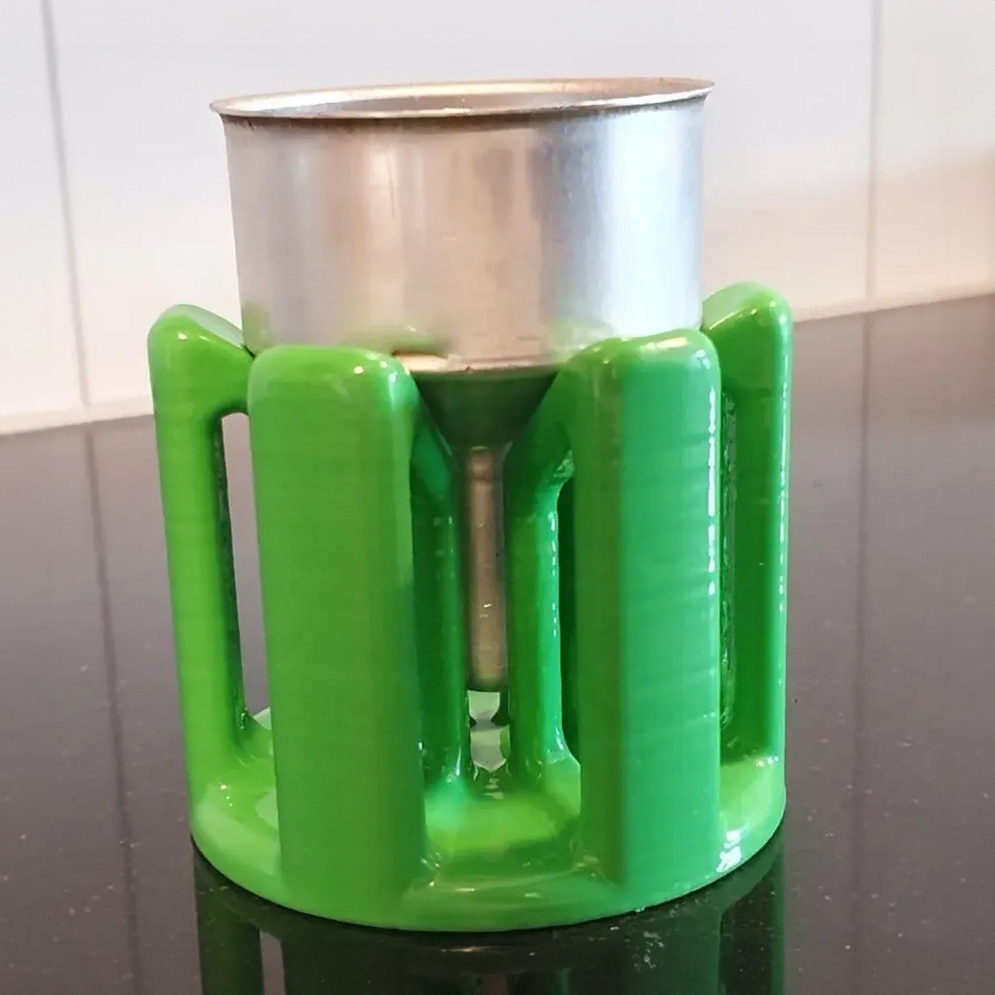 a green cup holder sitting on top of a table