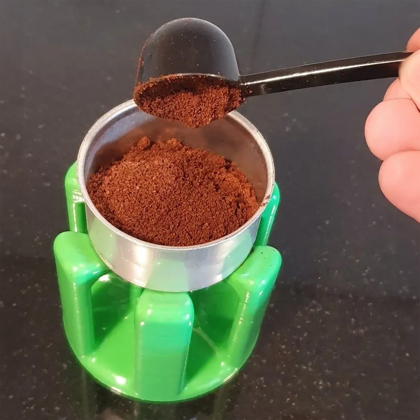 a person scooping cocoa into a cup