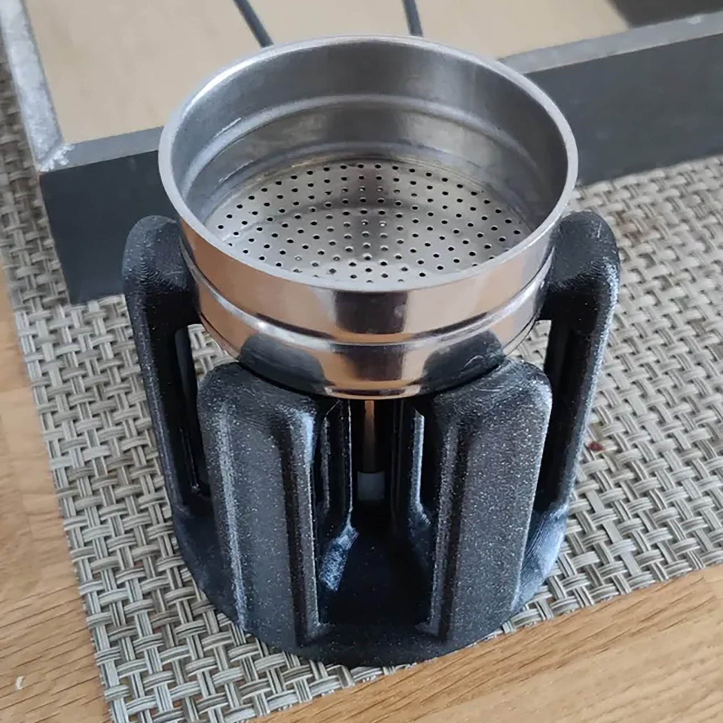 a metal pot sitting on top of a wooden table