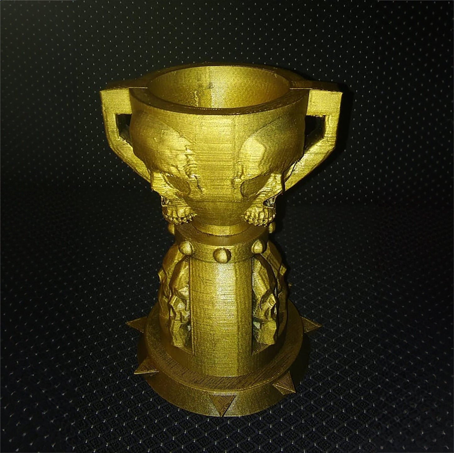 a gold cup with a dragon decoration on it