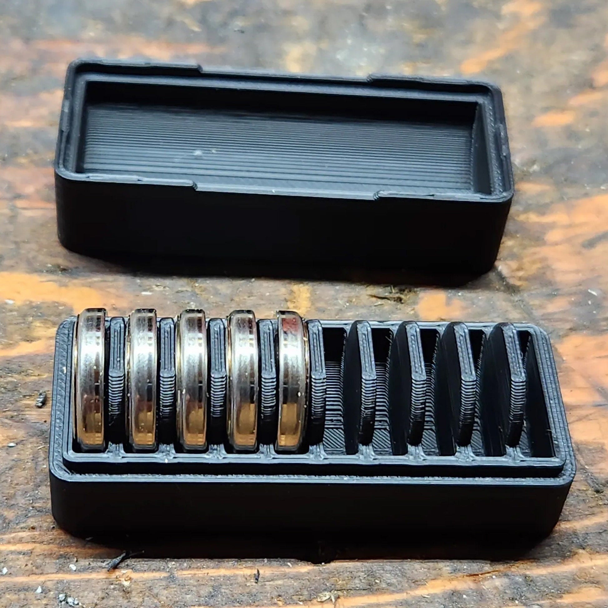 a couple of black trays sitting on top of a wooden table