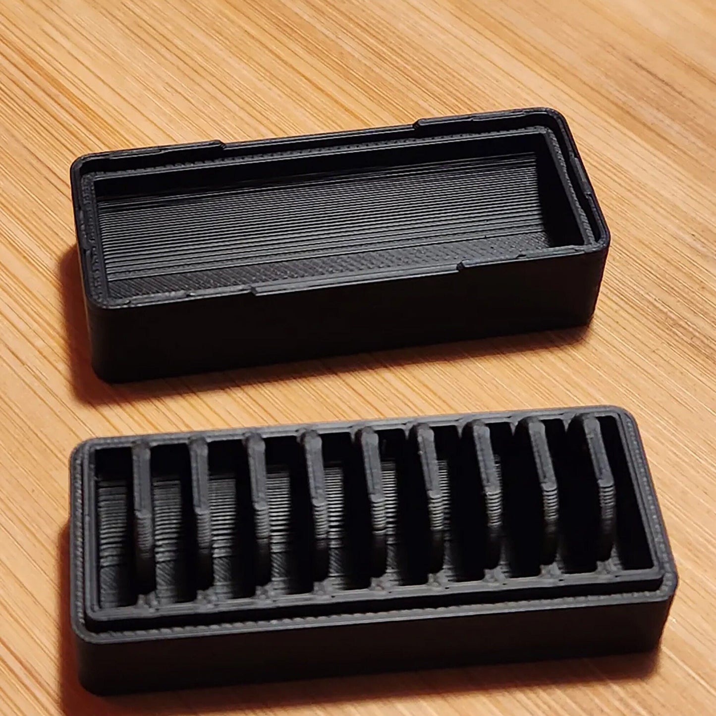 a couple of black trays sitting on top of a wooden table