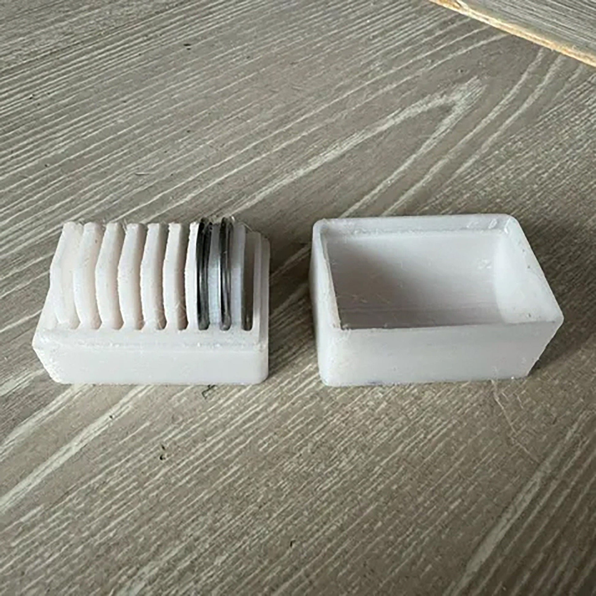 a couple of white dishes sitting on top of a wooden table