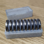 CR2032 coin cell storage box with a slotted tray holding batteries on edge, view 2