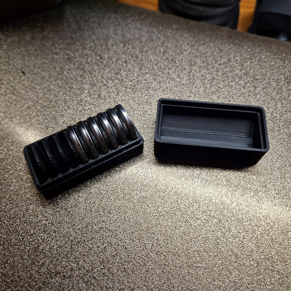 CR2032 coin cell storage box with a slotted tray holding batteries on edge, view 4