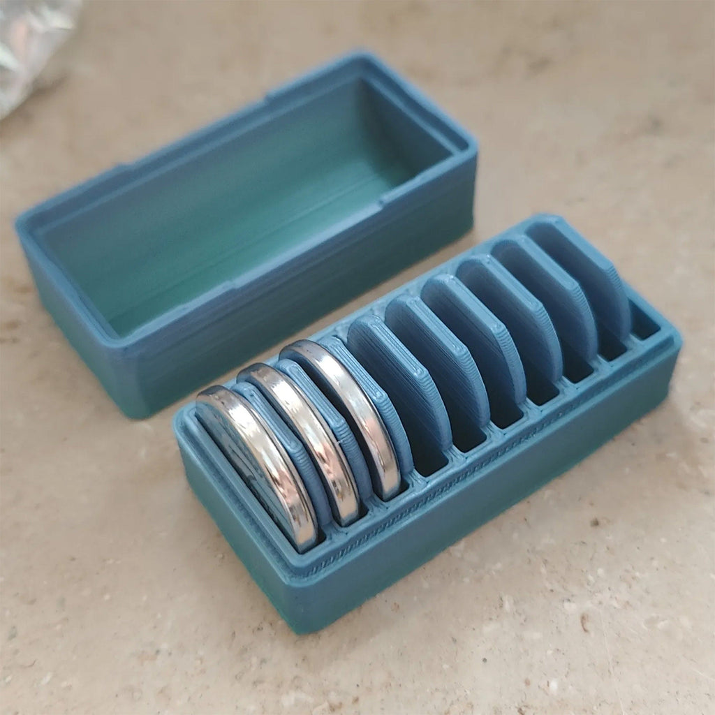 CR2032 coin cell storage box with a slotted tray holding batteries on edge, view 5