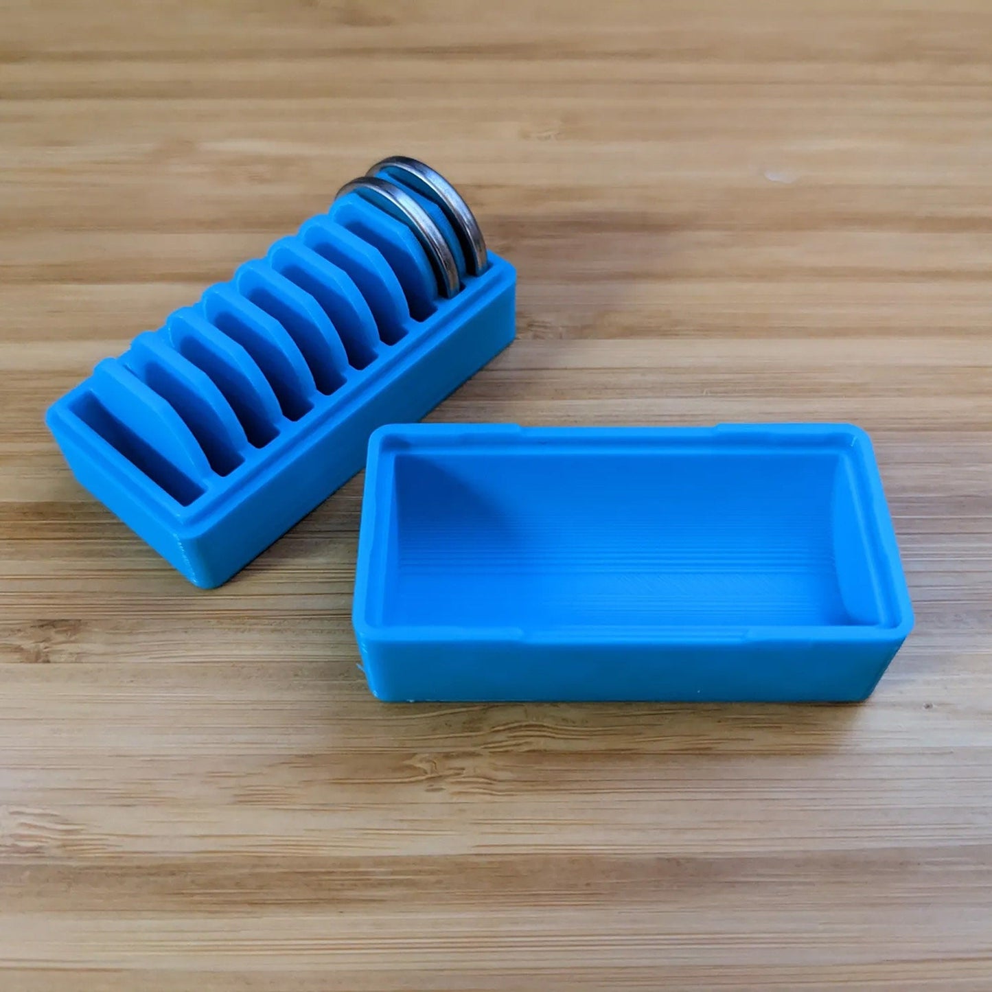 a couple of blue containers sitting on top of a wooden table