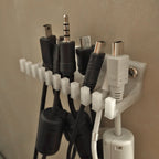 Slotted cable holder organizer docking charging cable ends on a desk edge, view 4