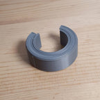 Reusable hex-shaped cable bundling ring snapped around a coiled charging cord, view 2