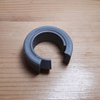 Reusable hex-shaped cable bundling ring snapped around a coiled charging cord, view 3