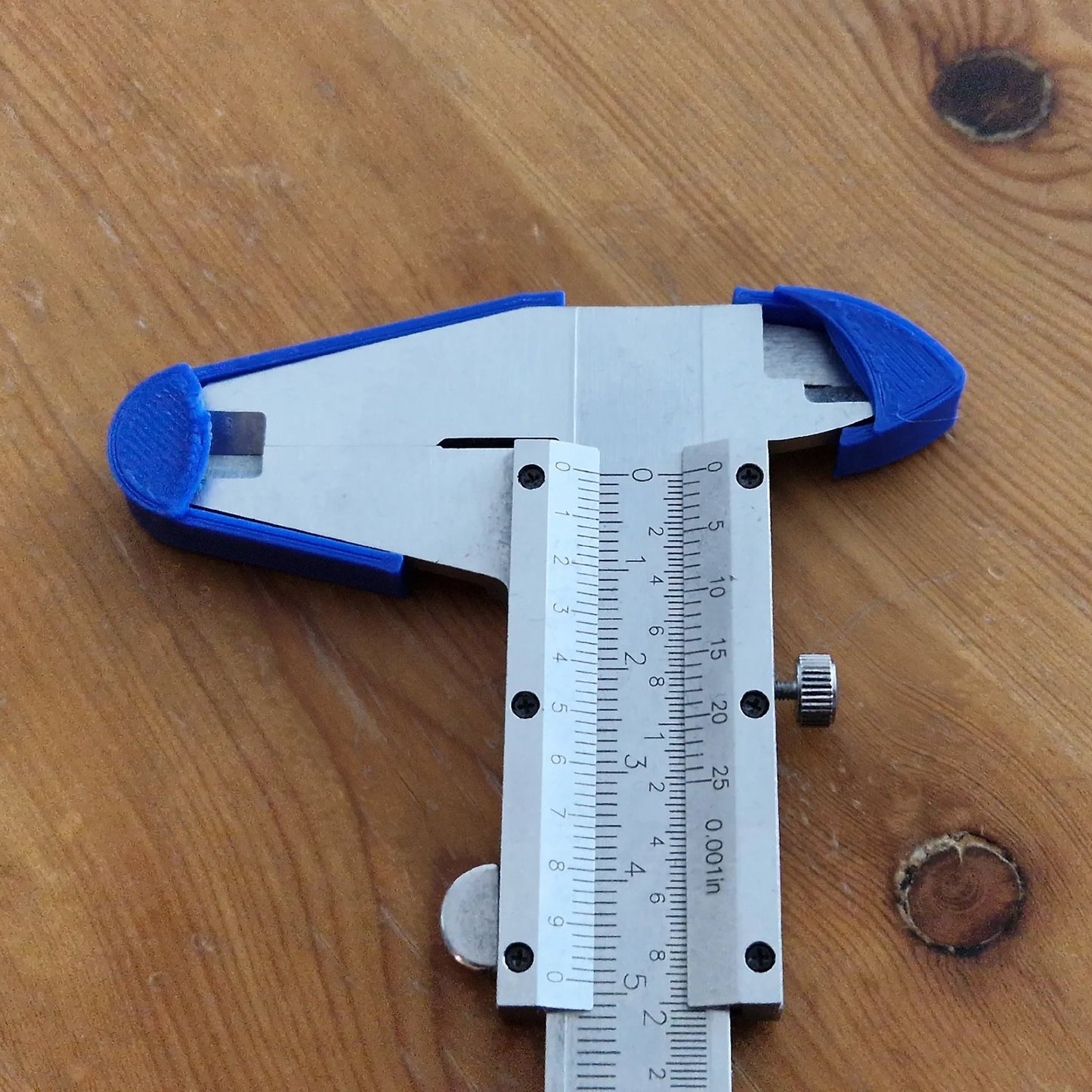 a blue and white measuring tool on a wooden table