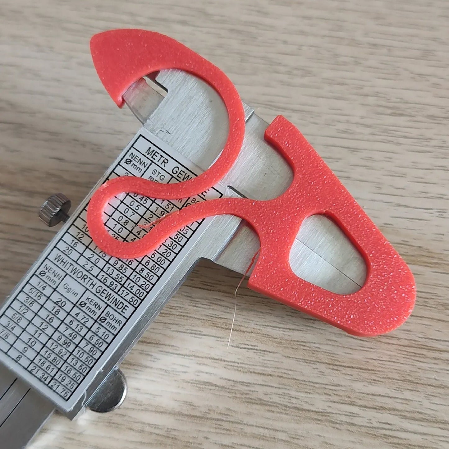 a pair of scissors sitting on top of a wooden table