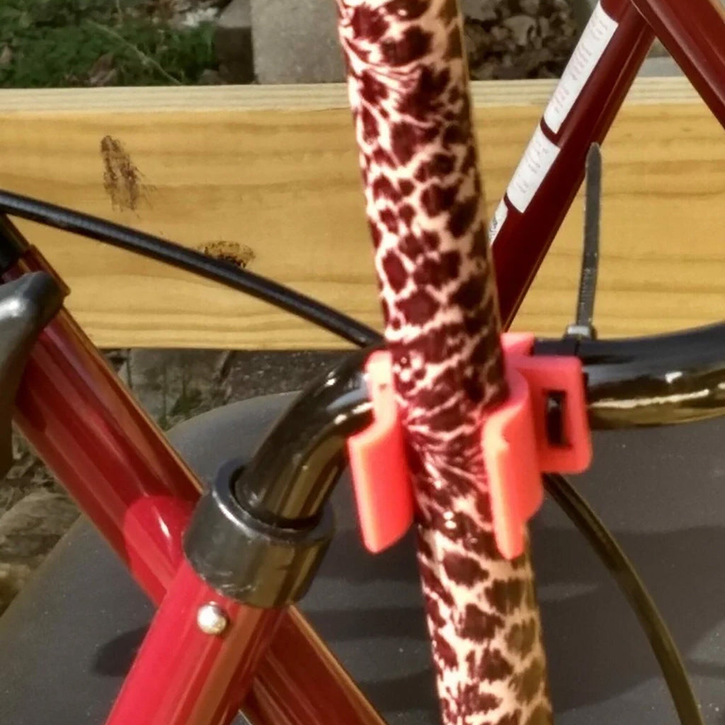 Cane holder clip attaching a walking cane to a walker or wheelchair frame, view 3