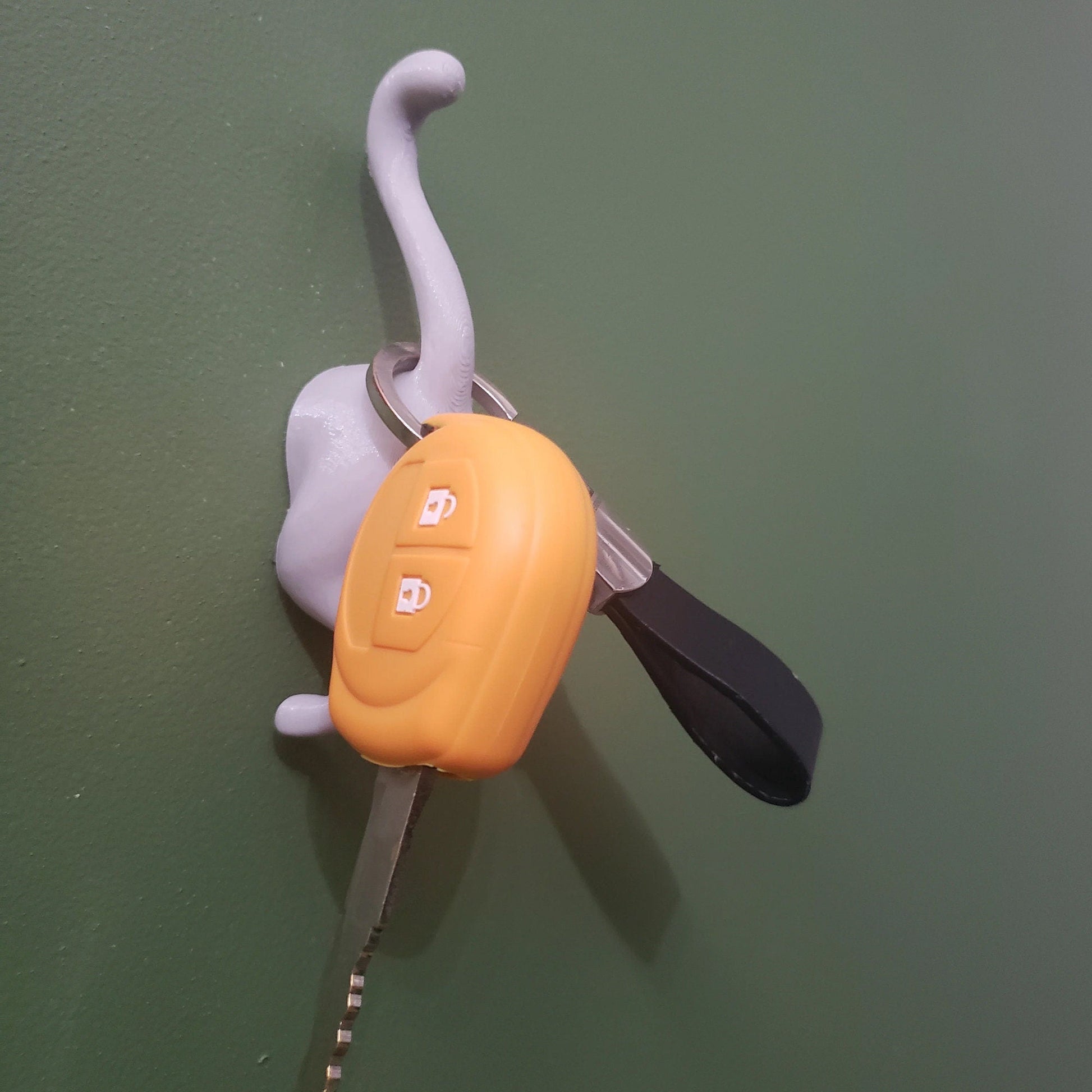 a plastic key holder with scissors attached to it