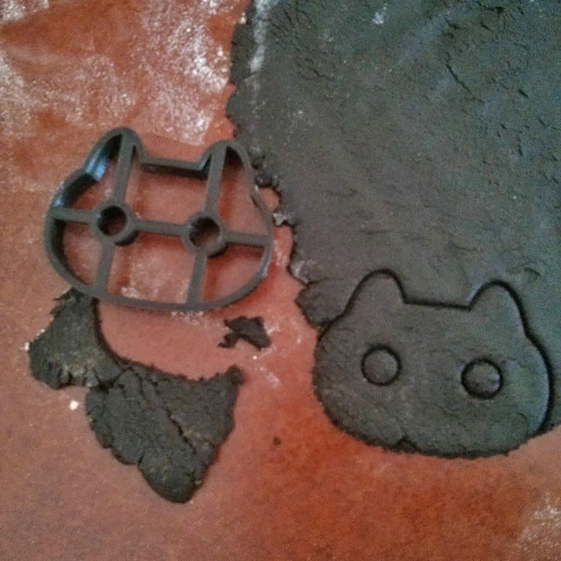 a cookie cutter laying on top of a cookie