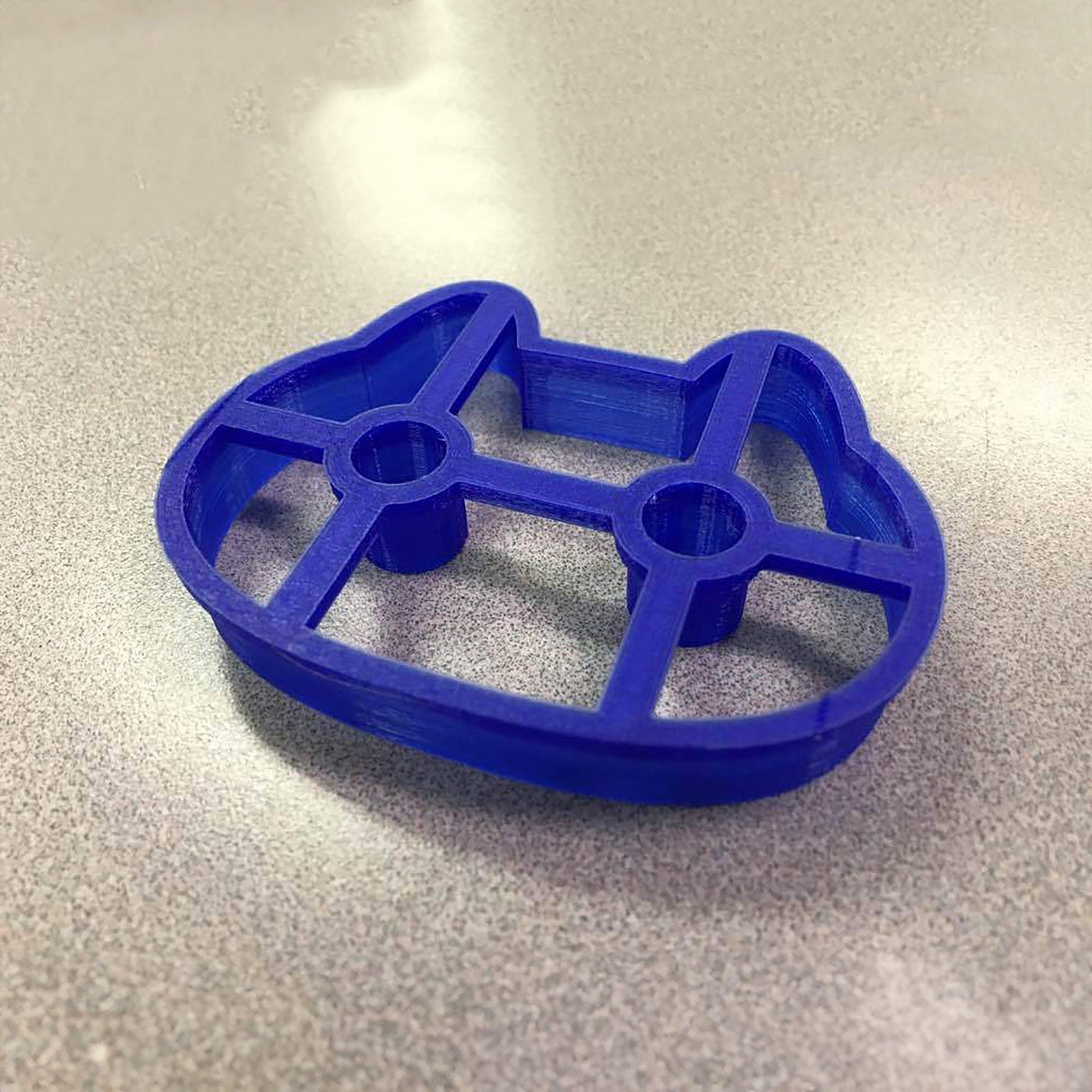 a blue cookie cutter sitting on top of a table