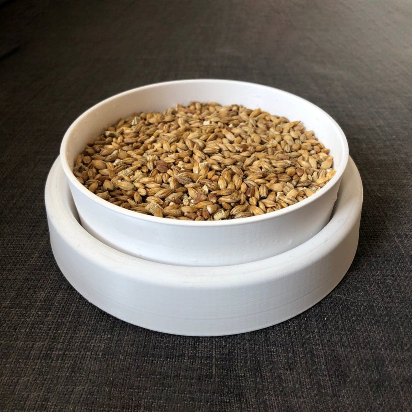 a white bowl filled with grain on top of a table